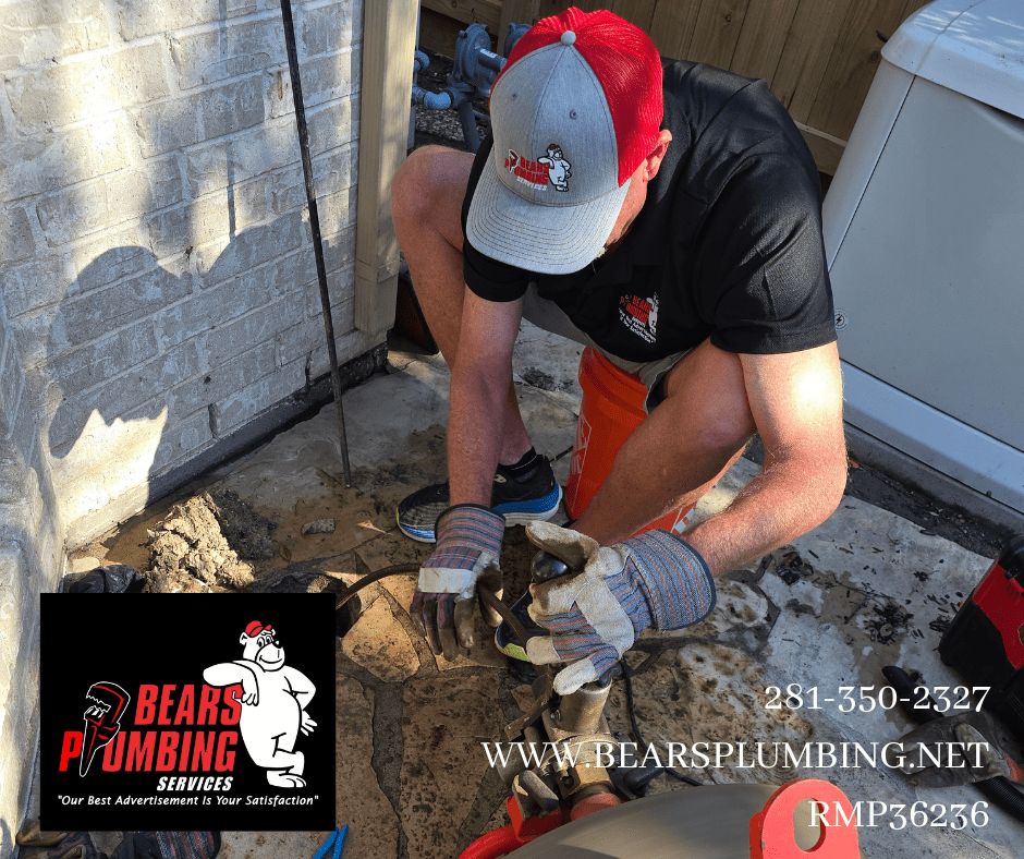 Bear from Bear’s Plumbing running a sewer machine to remove an obstruction in a customer’s sewer line.