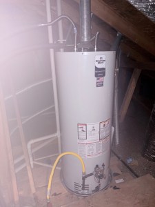 50-gallon natural gas water heater professionally installed in an attic with proper venting and safety measures.