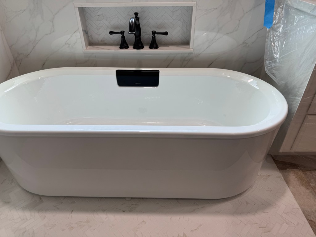Freestanding cast iron bathtub installed during a custom bathroom remodel in the Woodforest neighborhood of Montgomery, Texas before being relocated for the homeowner's preferred placement.